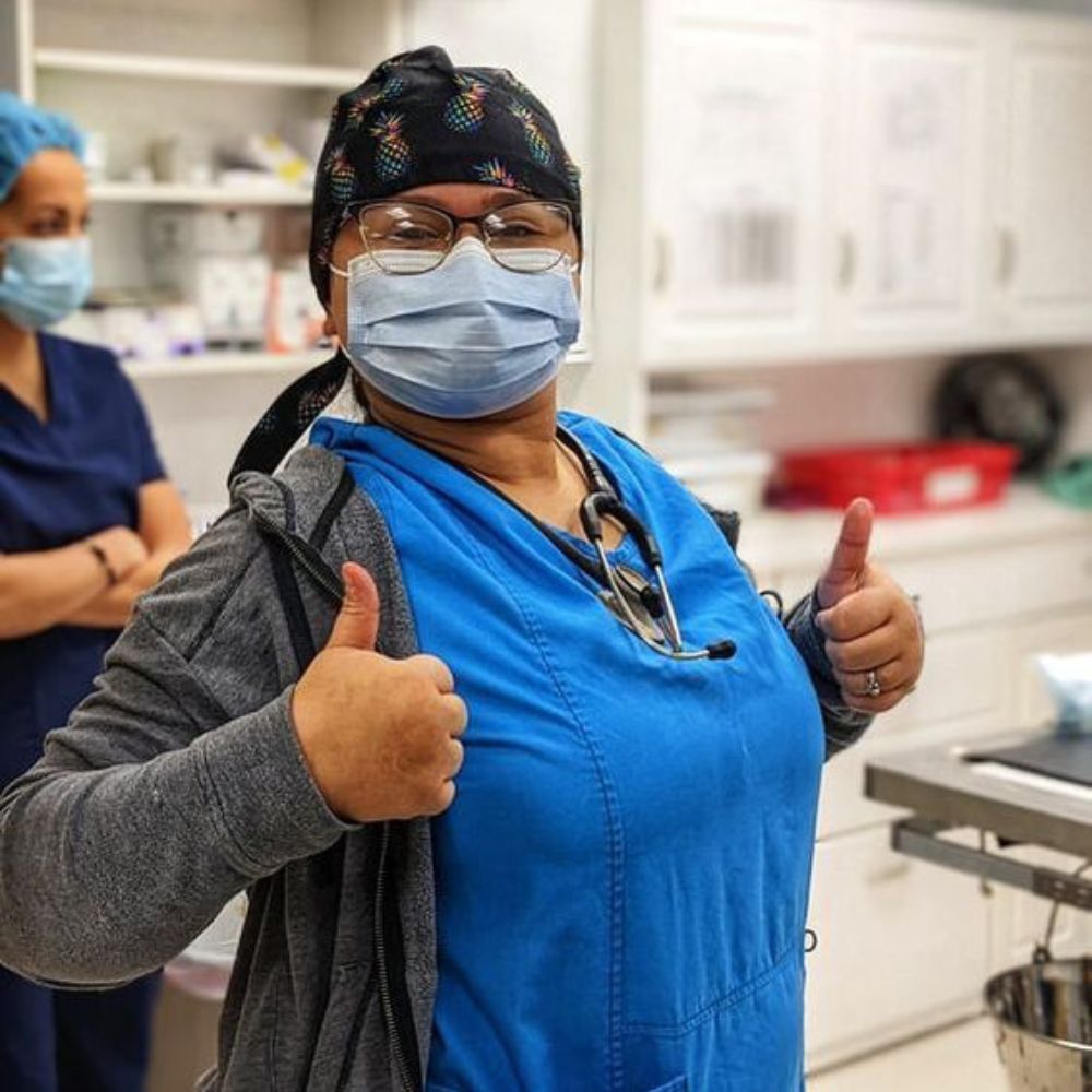 a vet wearing a mask and giving a thumbs up